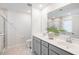 Clean, modern bathroom features double sinks, gray cabinets, a large mirror, and a glass-enclosed shower at 705 Squire Pope Rd, Summerville, SC 29486