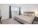 Cozy bedroom featuring a comfortable bed, soft carpet, a window with curtains, and bedside tables with lamps at 705 Squire Pope Rd, Summerville, SC 29486