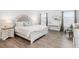 Bright bedroom with a large bed, nightstand, and decor, featuring wooden floors and modern design at 705 Squire Pope Rd, Summerville, SC 29486