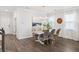 Chic dining room featuring a white table, stylish chairs, chandelier lighting and hardwood flooring at 705 Squire Pope Rd, Summerville, SC 29486