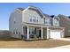 Attractive home featuring a covered porch, a two-car garage, and well-maintained landscaping at 705 Squire Pope Rd, Summerville, SC 29486