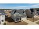 Charming two-story home with gray siding, a covered front porch, well-maintained landscaping, and a two car garage at 705 Squire Pope Rd, Summerville, SC 29486