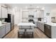 Well-lit kitchen with gray cabinets, stainless steel appliances, and center island with seating at 705 Squire Pope Rd, Summerville, SC 29486