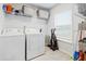 Functional laundry room with a washer, dryer, shelving, and a window for natural light at 705 Squire Pope Rd, Summerville, SC 29486