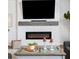 Stylish living room showcases a modern fireplace with mounted TV and well decorated coffee table at 705 Squire Pope Rd, Summerville, SC 29486