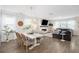 Elegant dining and living area with a modern fireplace, hardwood floors, and abundant natural light at 705 Squire Pope Rd, Summerville, SC 29486