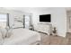 Bright main bedroom with a large bed, dresser, decor, featuring wooden floors and modern design at 705 Squire Pope Rd, Summerville, SC 29486