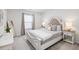 Cozy main bedroom featuring a comfortable bed, soft carpet, a window with curtains, and bedside tables with lamps at 705 Squire Pope Rd, Summerville, SC 29486