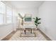 Bright office space featuring a sleek white desk, stylish rug, and ample natural light from the large window at 705 Squire Pope Rd, Summerville, SC 29486