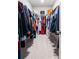 Spacious walk-in closet with ample hanging space, shelving, and carpet flooring, perfect for organizing your wardrobe at 705 Squire Pope Rd, Summerville, SC 29486