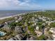 Beautiful aerial view of a coastal community with beach access, lush greenery, and a serene atmosphere at 73 Fairway Dunes Ln, Isle of Palms, SC 29451
