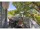 Charming balcony featuring an outdoor dining table and chair set with views of neighborhood trees at 73 Fairway Dunes Ln, Isle of Palms, SC 29451