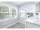 Well-lit bathroom featuring a marble vanity and large windows for natural light at 73 Fairway Dunes Ln, Isle of Palms, SC 29451