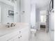 Bathroom with a toilet, white vanity with chrome fixtures and marble countertop at 73 Fairway Dunes Ln, Isle of Palms, SC 29451