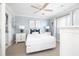Charming bedroom featuring a ceiling fan and stylish decor with a view to an ensuite bath at 73 Fairway Dunes Ln, Isle of Palms, SC 29451