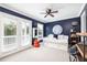 Cozy bedroom with daybed, ceiling fan, and balcony access for a light-filled space at 73 Fairway Dunes Ln, Isle of Palms, SC 29451