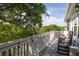 Relaxing outdoor deck area with comfortable rocking chairs and scenic views of lush greenery at 73 Fairway Dunes Ln, Isle of Palms, SC 29451