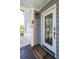 Charming home entrance with a welcome mat and decorative accents on the light blue siding at 73 Fairway Dunes Ln, Isle of Palms, SC 29451
