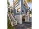Coastal home featuring multiple levels with decks, covered parking, and white latticework at 73 Fairway Dunes Ln, Isle of Palms, SC 29451