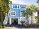 Charming coastal home with a light blue exterior, white trim, and multiple outdoor staircases to upper levels at 73 Fairway Dunes Ln, Isle of Palms, SC 29451