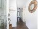 Inviting foyer hallway with hardwood flooring and decorative mirror on the wall at 73 Fairway Dunes Ln, Isle of Palms, SC 29451