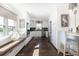 Modern kitchen with white cabinets, stainless steel appliances, breakfast bar, and window bench seating at 73 Fairway Dunes Ln, Isle of Palms, SC 29451