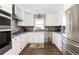 Well-appointed kitchen featuring stainless appliances, granite counters, white cabinets, and stylish backsplash at 73 Fairway Dunes Ln, Isle of Palms, SC 29451