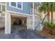 Covered parking area with latticework, stairs to the home's entrance, and space for a golf cart at 73 Fairway Dunes Ln, Isle of Palms, SC 29451