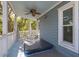 Cozy covered porch includes seating, fan, and an enclosed hot tub for outdoor relaxation at 73 Fairway Dunes Ln, Isle of Palms, SC 29451
