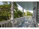 Inviting covered porch offers a serene retreat with rocking chairs and greenery views at 73 Fairway Dunes Ln, Isle of Palms, SC 29451