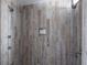 Modern shower featuring wood-look tile walls, multiple shower heads and shower products at 73 Fairway Dunes Ln, Isle of Palms, SC 29451