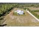 Aerial view of a sprawling property with a large home, expansive grounds, and lush greenery at 733 Oakridge View Trl, Ridgeville, SC 29472