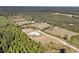 Aerial view of the modern farmhouse on a large lot surrounded by trees at 733 Oakridge View Trl, Ridgeville, SC 29472