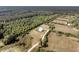 Aerial view of the modern farmhouse on a large lot surrounded by trees at 733 Oakridge View Trl, Ridgeville, SC 29472