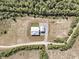 Aerial view of the modern farmhouse on a large lot surrounded by trees at 733 Oakridge View Trl, Ridgeville, SC 29472
