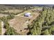 Aerial view of the modern farmhouse on a large lot surrounded by trees at 733 Oakridge View Trl, Ridgeville, SC 29472