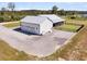 Aerial view of a home featuring a spacious garage, a covered patio, and a manicured lawn at 733 Oakridge View Trl, Ridgeville, SC 29472