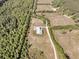 Aerial view of the modern farmhouse on a large lot surrounded by trees at 733 Oakridge View Trl, Ridgeville, SC 29472