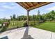 This covered patio features a view of a fenced-in backyard, a manicured lawn, and landscaping at 733 Oakridge View Trl, Ridgeville, SC 29472