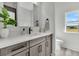 Bathroom features a modern vanity with sleek faucet, mirror, leafy plant, and a toilet at 733 Oakridge View Trl, Ridgeville, SC 29472