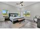 Bright bedroom with a vaulted ceiling, a ceiling fan, three windows, and stylish furnishings at 733 Oakridge View Trl, Ridgeville, SC 29472