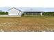 View of the modern farmhouse-style home with a fenced-in backyard and metal roof at 733 Oakridge View Trl, Ridgeville, SC 29472