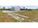 The home has a large garage/workshop and the beginnings of a driveway at 733 Oakridge View Trl, Ridgeville, SC 29472