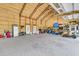 A large garage with storage, a golf bag, and a lawn mower offers ample space for vehicles and equipment at 733 Oakridge View Trl, Ridgeville, SC 29472