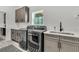 Modern laundry room with gray cabinets, gray appliances, countertop, and view to outdoors at 733 Oakridge View Trl, Ridgeville, SC 29472
