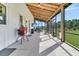 This outdoor patio has wood rafters, outdoor seating, a grill, and an outdoor TV for entertainment at 733 Oakridge View Trl, Ridgeville, SC 29472