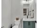 Stylish powder room featuring a modern vanity with blue cabinetry, black hardware and fixtures, and a rectangular mirror at 733 Oakridge View Trl, Ridgeville, SC 29472