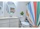 This bathroom features a round mirror, sleek vanity, and a patterned shower curtain at 7965 Edgebrook Cir # F, North Charleston, SC 29418