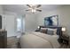 Staged primary bedroom with ceiling fan and adjoining bathroom at 7965 Edgebrook Cir # F, North Charleston, SC 29418