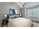This cozy bedroom features a ceiling fan, neutral walls, large window and stylish decor at 7965 Edgebrook Cir # F, North Charleston, SC 29418